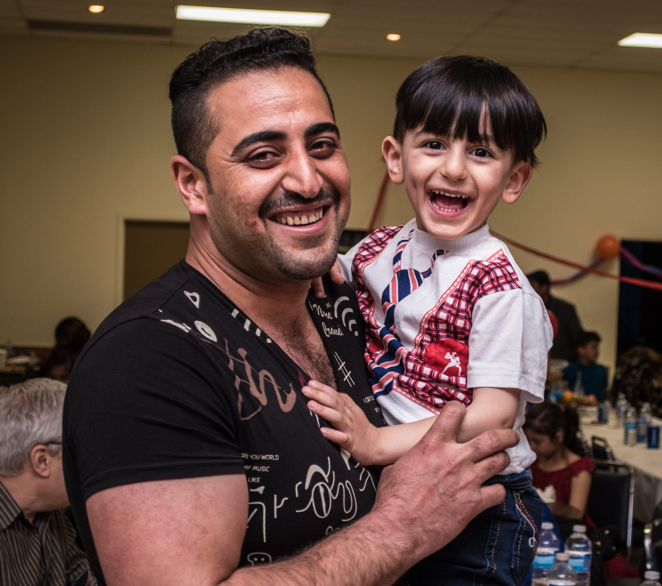 Man holding happy boy